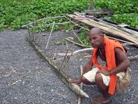 Tomas Taleo Kreno touches the canoe’s float.